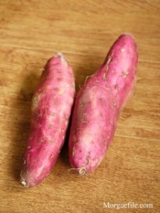 Red sweet potato roots on table