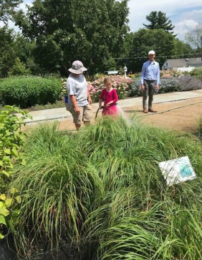Child and gardeners at gardens at White Flower Farm