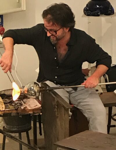 Man Blowing Glass in studio in Venice, Italy