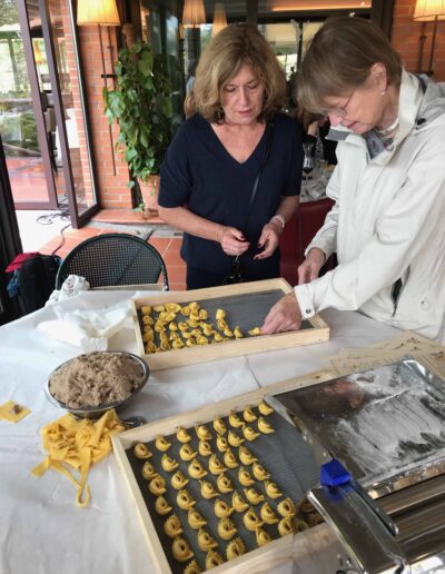 Two women making tortellini in Italy