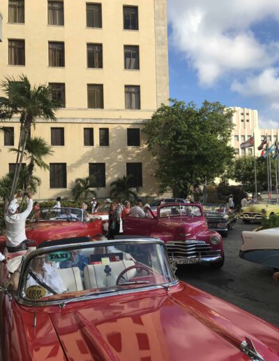 Group Riding Old Cars in Cuba
