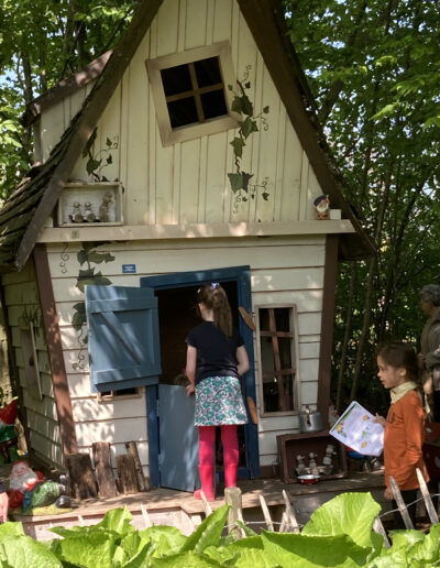 Kids visiting small playhouse in a garden